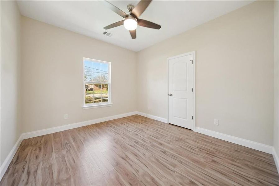 Spare room featuring ceiling fan and light hardwood / wood-style flooring