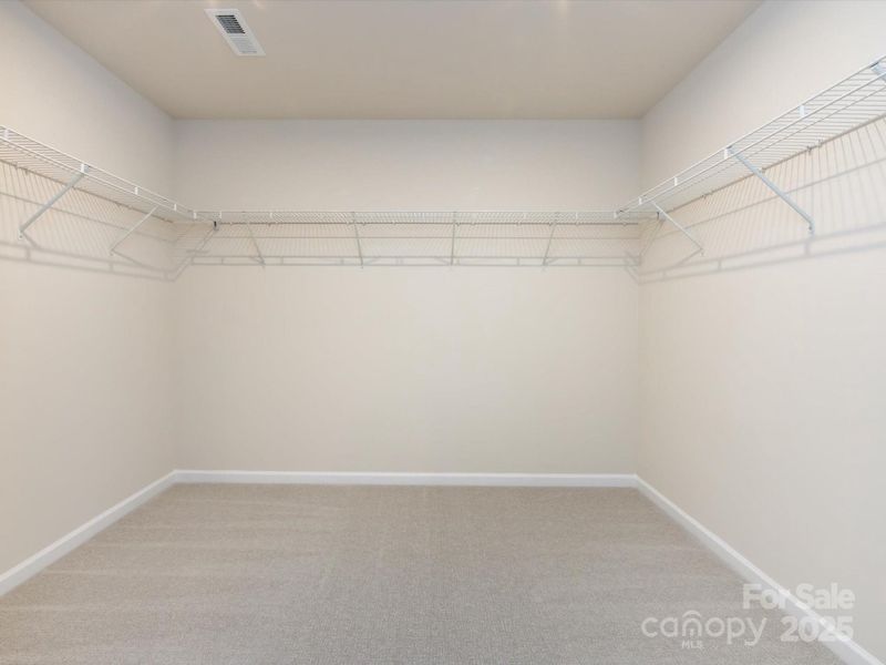 Huge primary walk-in closet.