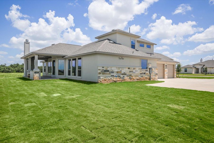 Front exterior of a new home in Leander Estates, Leander, TX, highlighting curb appeal (Image 16).