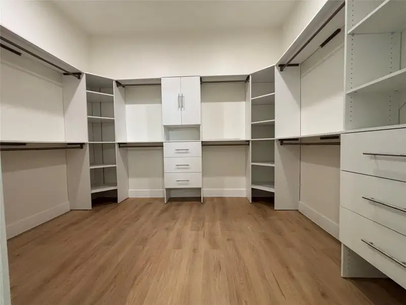 Ample storage solutions abound in this well-appointed walk-in closet featuring pristine built-ins. Ample storage solutions abound in this well-appointed walk-in closet featuring pristine built-ins.