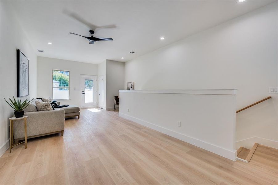 Living room featuring light hardwood / wood-style flooring and ceiling fan