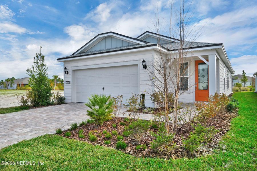 Front exterior of a new home in Del Webb Wildlight, Yulee, FL, highlighting curb appeal (Image 1). Front exterior of a new home in Del Webb Wildlight, Yulee, FL, highlighting curb appeal (Image 1).