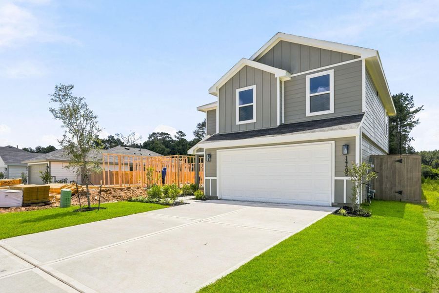 Front exterior of a new home in The Canopies, Splendora, TX, highlighting curb appeal (Image 6). Front exterior of a new home in The Canopies, Splendora, TX, highlighting curb appeal (Image 6).