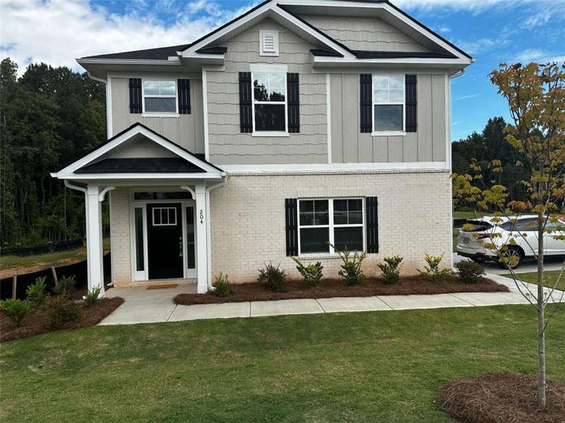 Front exterior of a new home in Canterbury Villas, Carrollton, GA, highlighting curb appeal (Image 1).