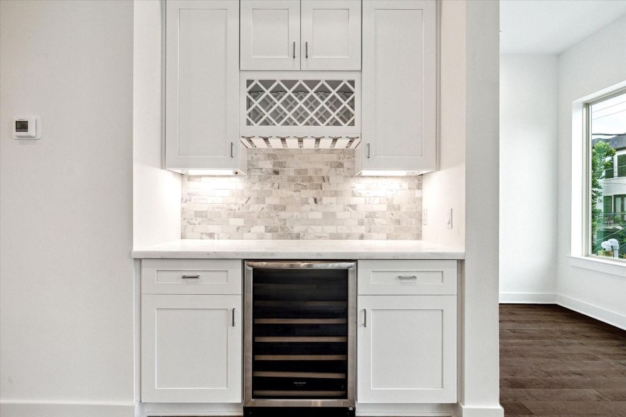 Wet Bar * Wine Refrigerator * Marble Backsplash * Lots of Cabinets * Wine Rack.