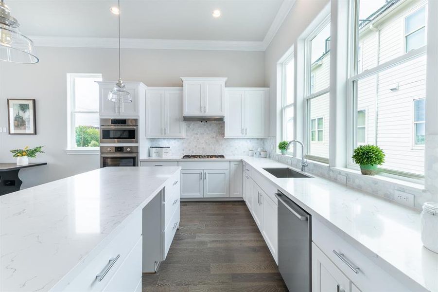 Light and bright kitchen with loads of countertop space and lots of cabinets with Bosch appliances.