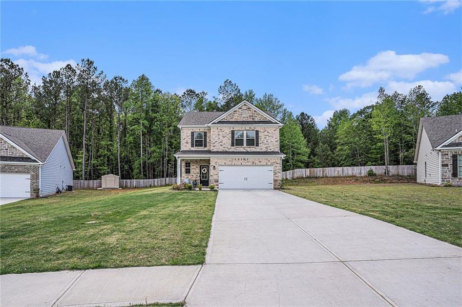 Front exterior of a new home in Vineyard Park, Griffin, GA, highlighting curb appeal (Image 24). Front exterior of a new home in Vineyard Park, Griffin, GA, highlighting curb appeal (Image 24).