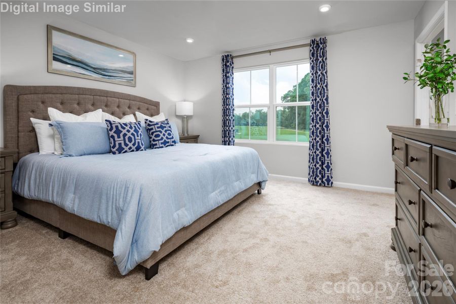 Retreat to the Serene Primary Bedroom, a Spacious Sanctuary Designed for Rest and Rejuvenation.