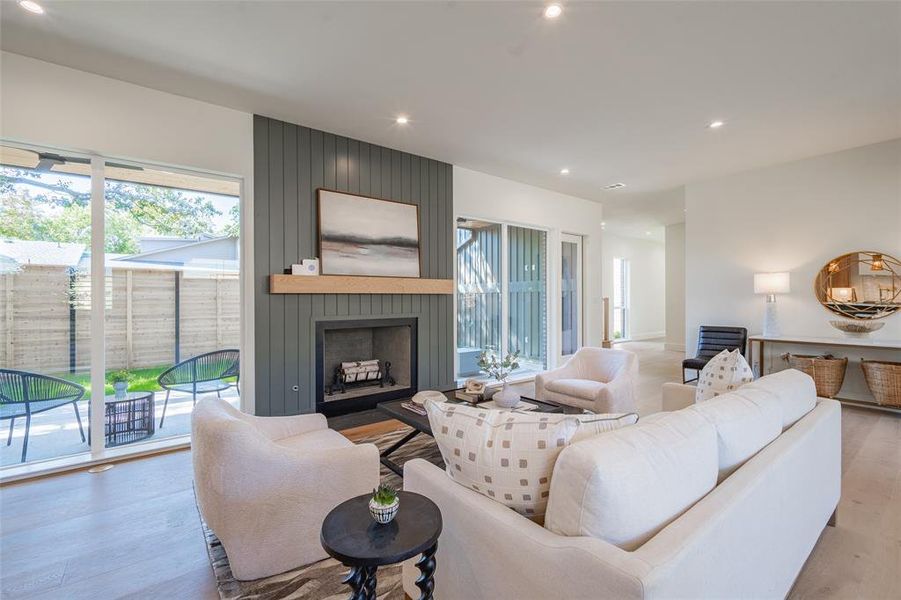 Living room featuring a large fireplace and light wood-type flooring