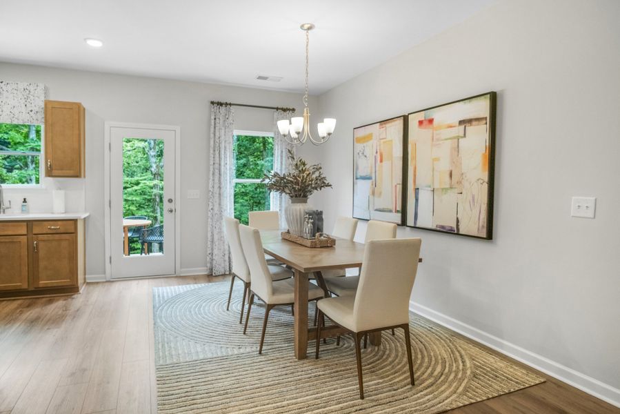 Got to love the designated dining area in the Pinehurst plan.  This picture is from our furnished and decorated model home in the community.  Window placement and color scheme may vary per unit location.  End unit will have extra side windows in DR.
