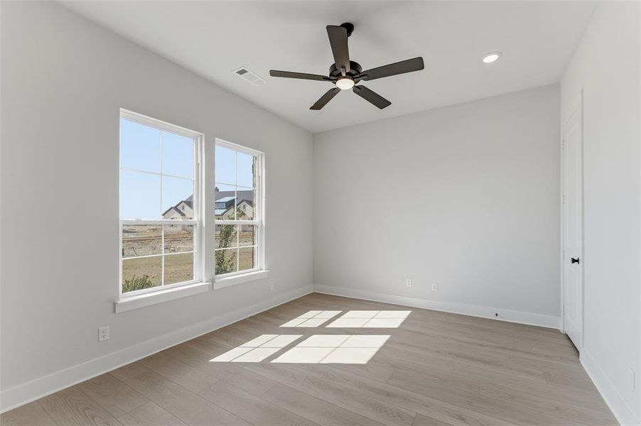Spare room featuring light wood-style flooring, a ceiling fan, and recessed lighting Spare room featuring light wood-style flooring, a ceiling fan, and recessed lighting