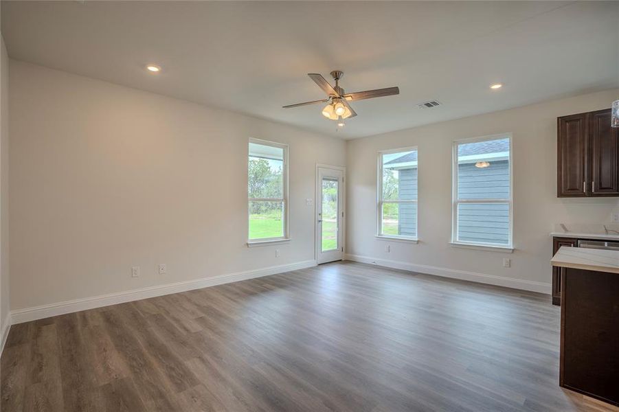 Dining Room with a center island, ceiling fan with notable chandelier, hanging light fixtures, and light hardwood / wood-style floors