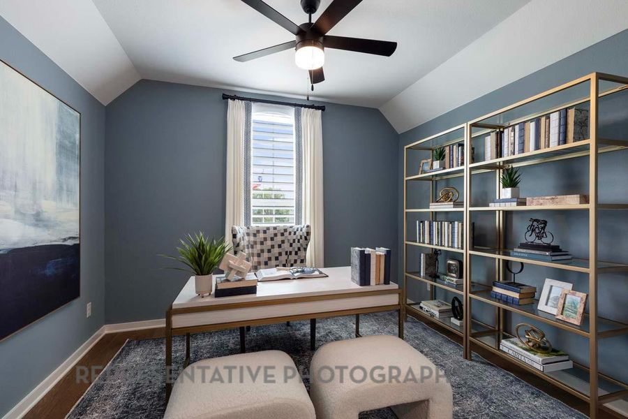 Home office with vaulted ceiling, dark wood-style floors, and a ceiling fan