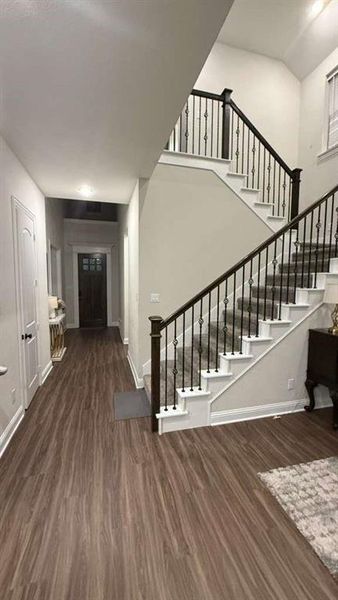 Foyer entrance featuring dark wood-type flooring and stairway