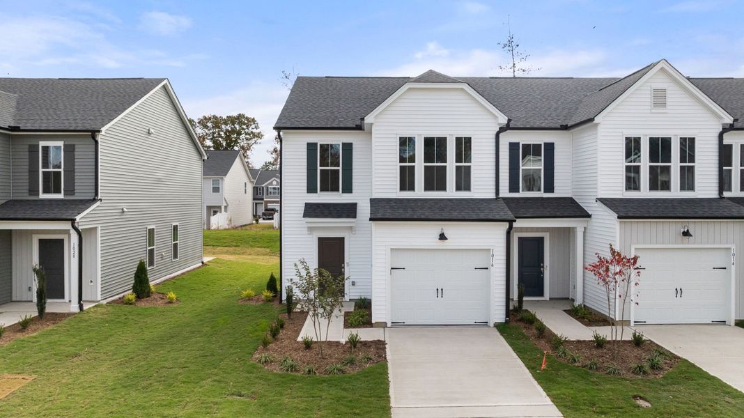 Front exterior of a new home in Poets Walk, Whitsett, NC, highlighting curb appeal (Image 2). Front exterior of a new home in Poets Walk, Whitsett, NC, highlighting curb appeal (Image 2).