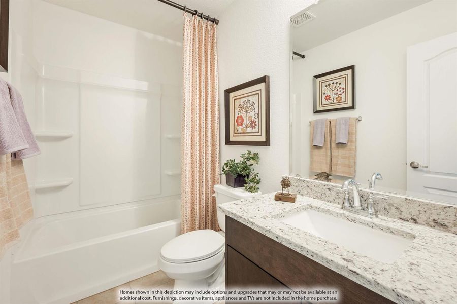 Bathroom with granite countertop vanity, white tub-shower combo, and dark wood cabinets Bathroom with granite countertop vanity, white tub-shower combo, and dark wood cabinets