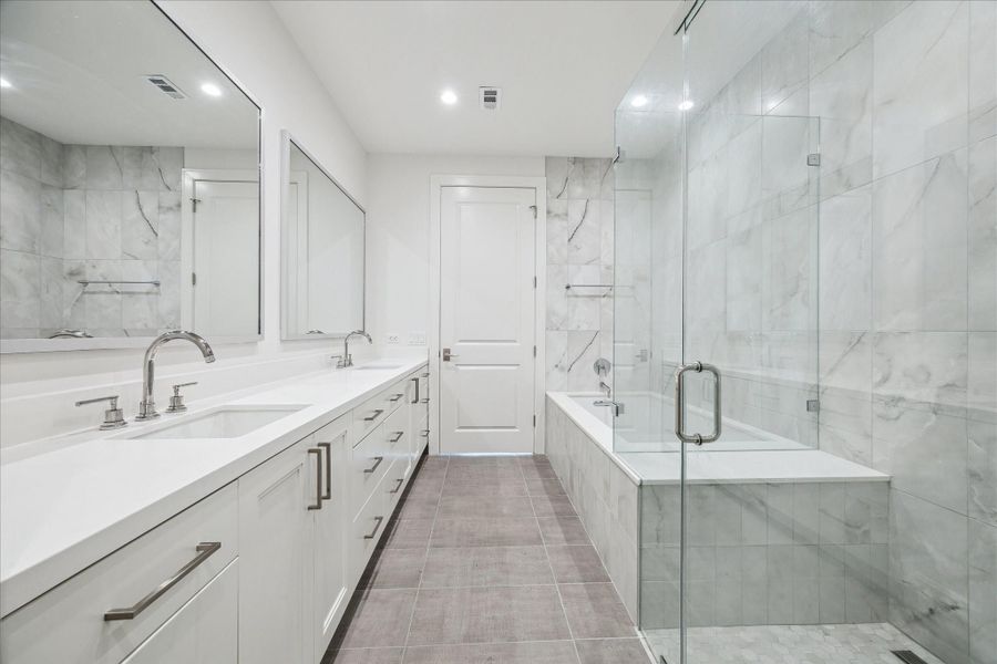 Primary bathroom featuring dual vanities, walk in shower, soaking tub, private W/C and linen closet. Primary bathroom featuring dual vanities, walk in shower, soaking tub, private W/C and linen closet.