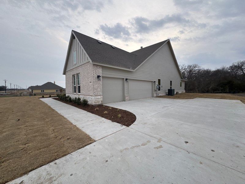 Front exterior of a new home in Terra Escalante, Blue Ridge, TX, highlighting curb appeal (Image 2). Front exterior of a new home in Terra Escalante, Blue Ridge, TX, highlighting curb appeal (Image 2).