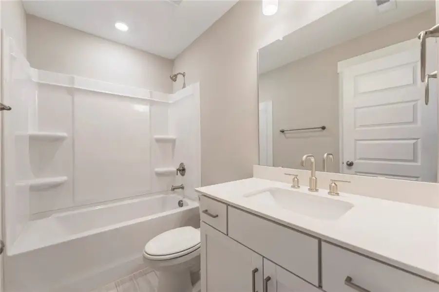 A well-appointed bath features modern fixtures and