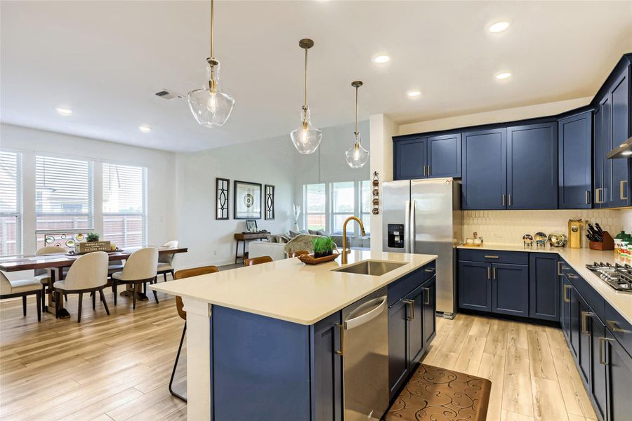 An open-concept living space integrates a well-appointed kitchen with a bright dining area, featuring a spacious island and contemporary finishes. An open-concept living space integrates a well-appointed kitchen with a bright dining area, featuring a spacious island and contemporary finishes.