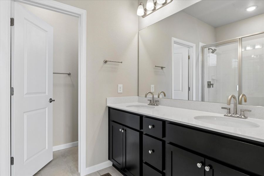 A bathroom with a large mirror.