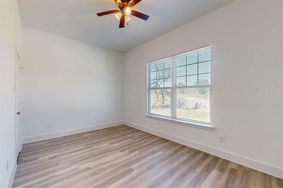 Unfurnished room with light wood-type flooring and ceiling fan