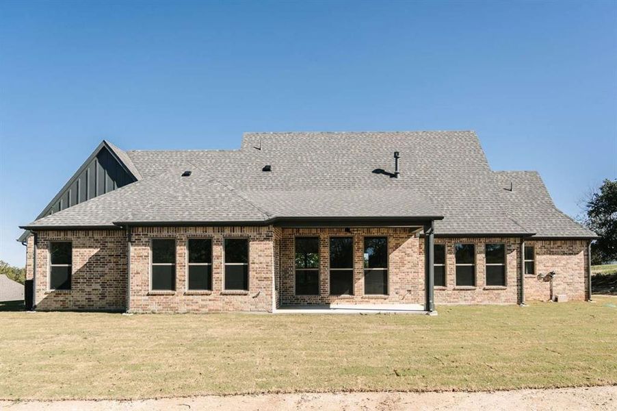 Back of house featuring a lawn