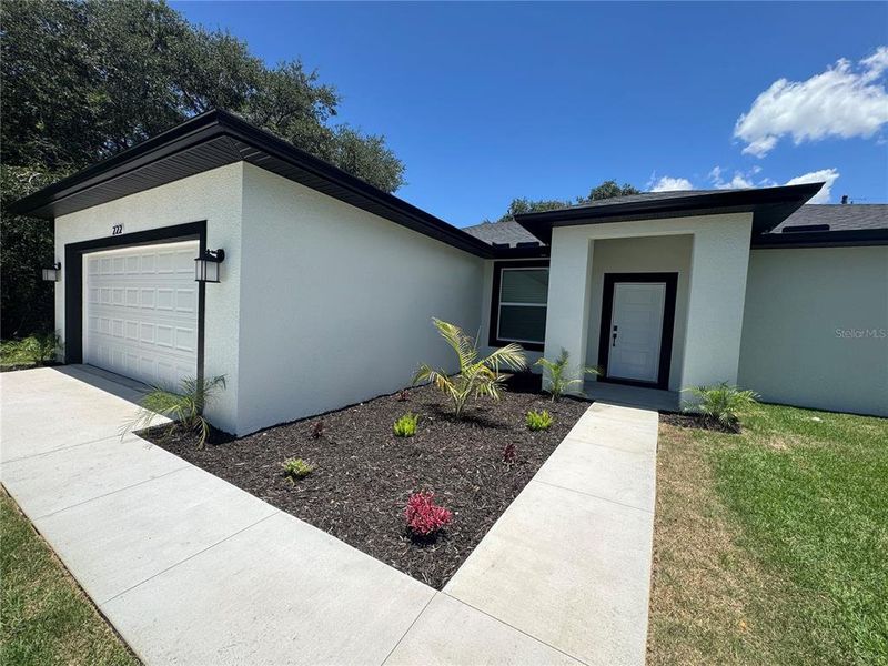 Front exterior of a new home in , Dundee, FL, highlighting curb appeal (Image 1). Front exterior of a new home in , Dundee, FL, highlighting curb appeal (Image 1).