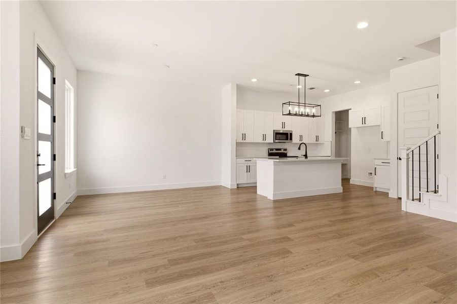 Unfurnished living room featuring light wood-style flooring and recessed lighting