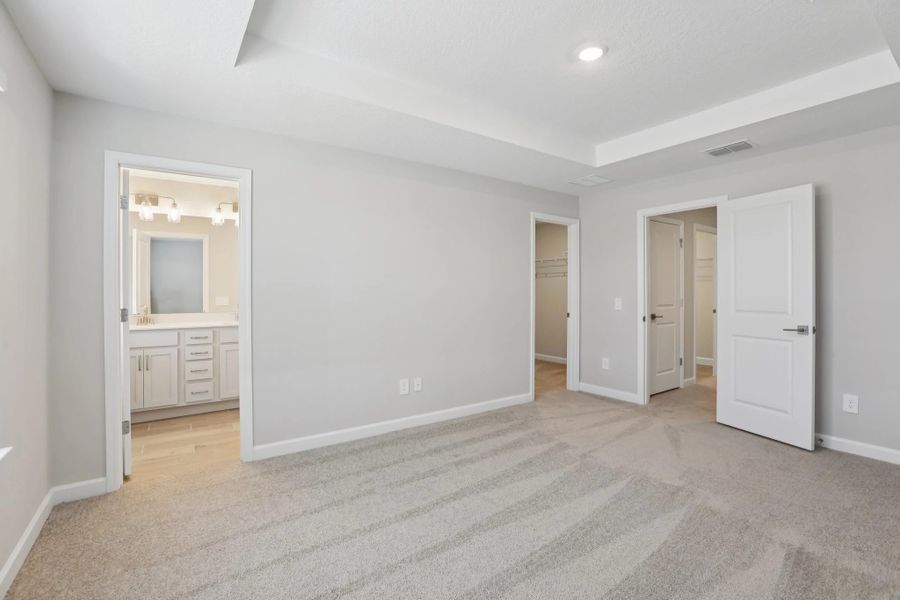 Primary suite provides a private oasis with an en suite bathroom and walk-in closet