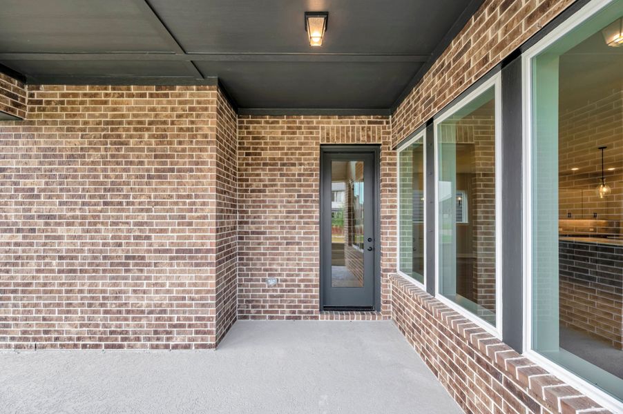 Exterior details and patio area of a home in Pomona - Grove Row Collection, Manvel (Image 4).