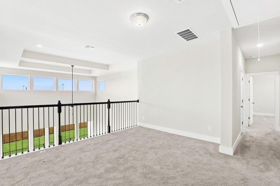 Unfurnished room featuring attic access, a raised ceiling, carpet, and recessed lighting Unfurnished room featuring attic access, a raised ceiling, carpet, and recessed lighting