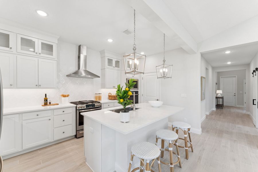 Kitchen with glass upper cabinets and tile backsplash