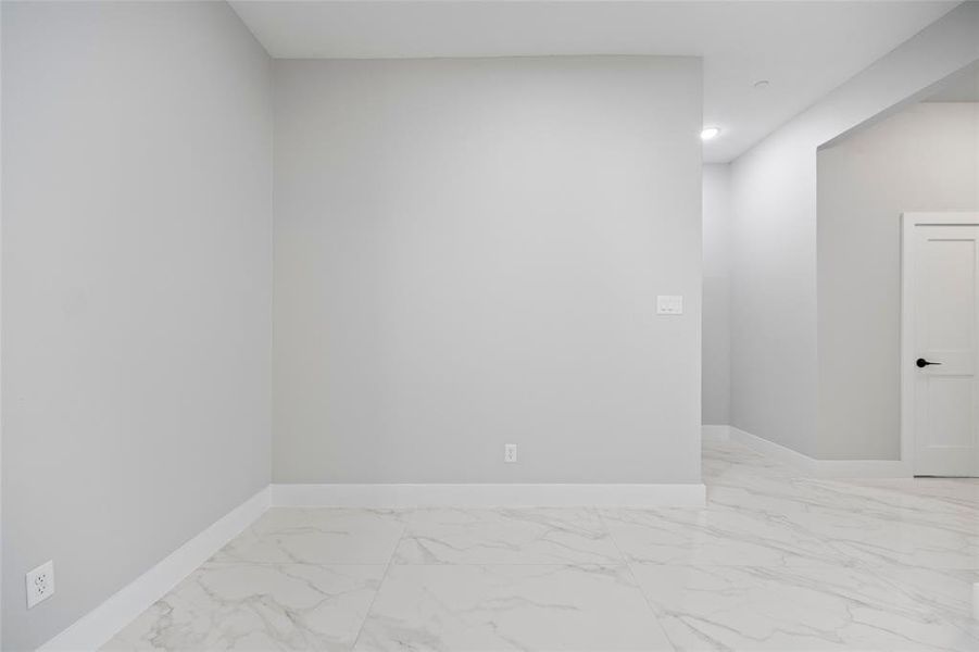 Unfurnished room with baseboards and marble finish floor