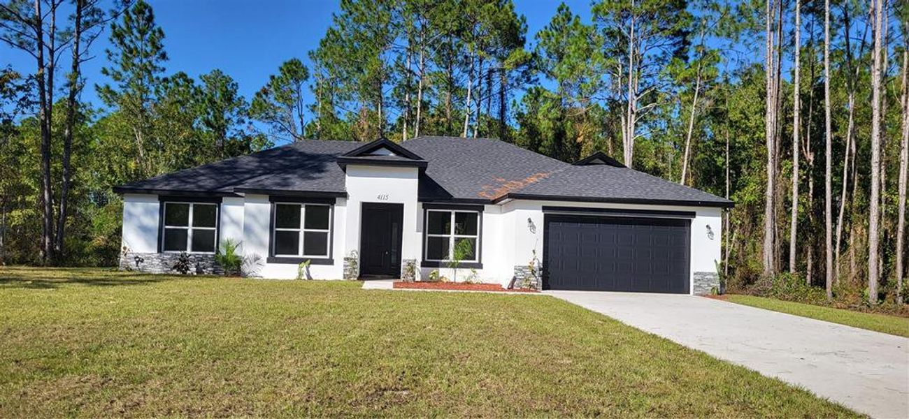 Front exterior of a new home in , Bunnell, FL, highlighting curb appeal (Image 1). Front exterior of a new home in , Bunnell, FL, highlighting curb appeal (Image 1).