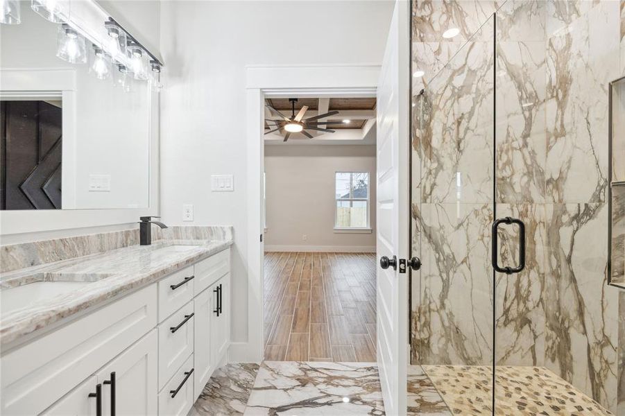 Bathroom with walk in shower, ceiling fan, wood-type flooring, and vanity