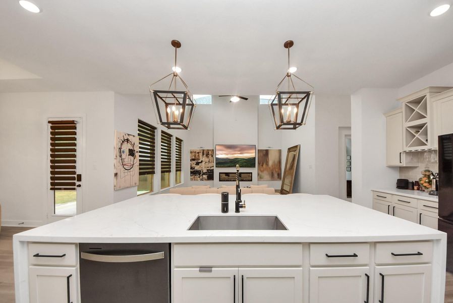 Beautiful view from the large quartz island into the open-concept living room, perfect for entertaining.