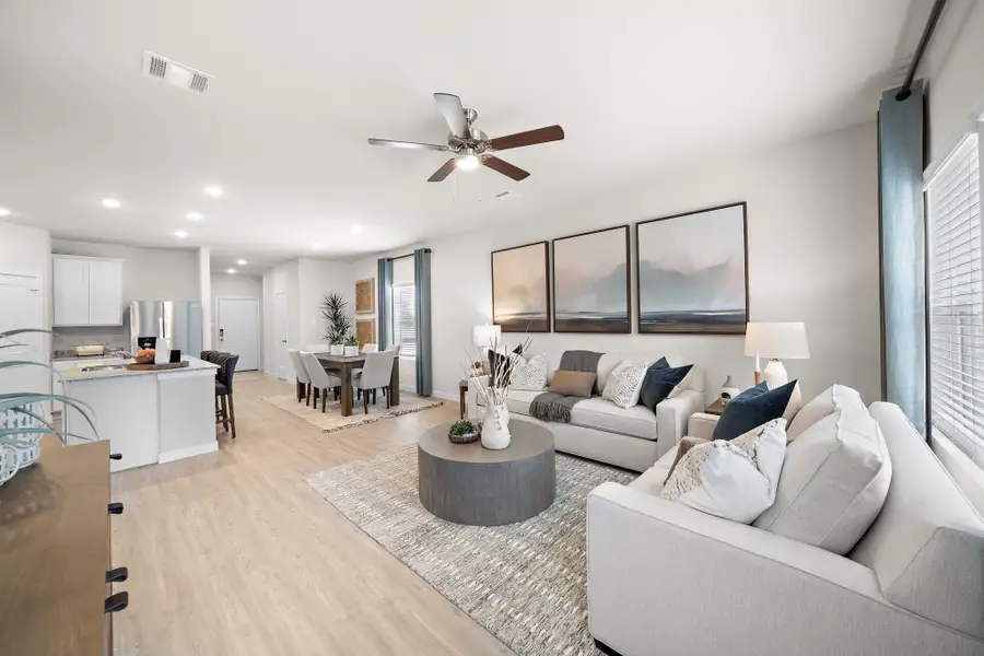 A living room with a large ceiling fan.