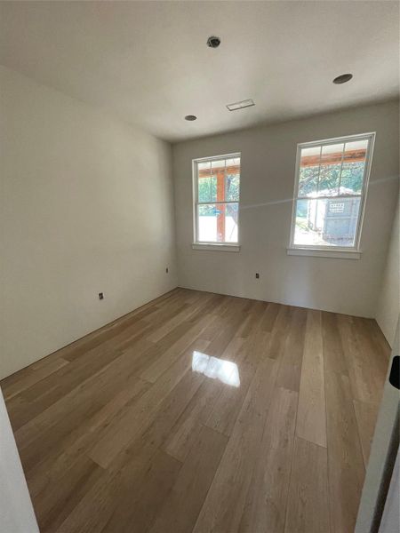 Light-filled secondary bedroom with large windows and beautiful flooring. Light-filled secondary bedroom with large windows and beautiful flooring.