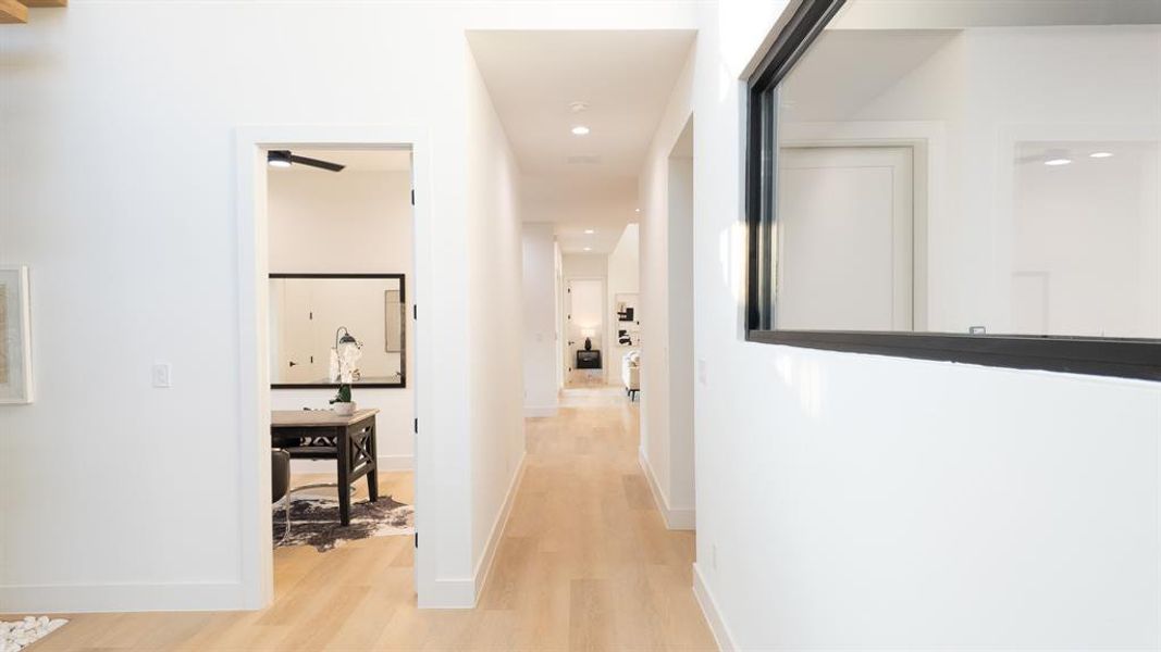 Hall with recessed lighting and light wood-style flooring