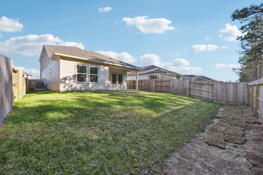 Exterior details and patio area of a home in Landing Meadows - Traditional Series, New Caney (Image 3).