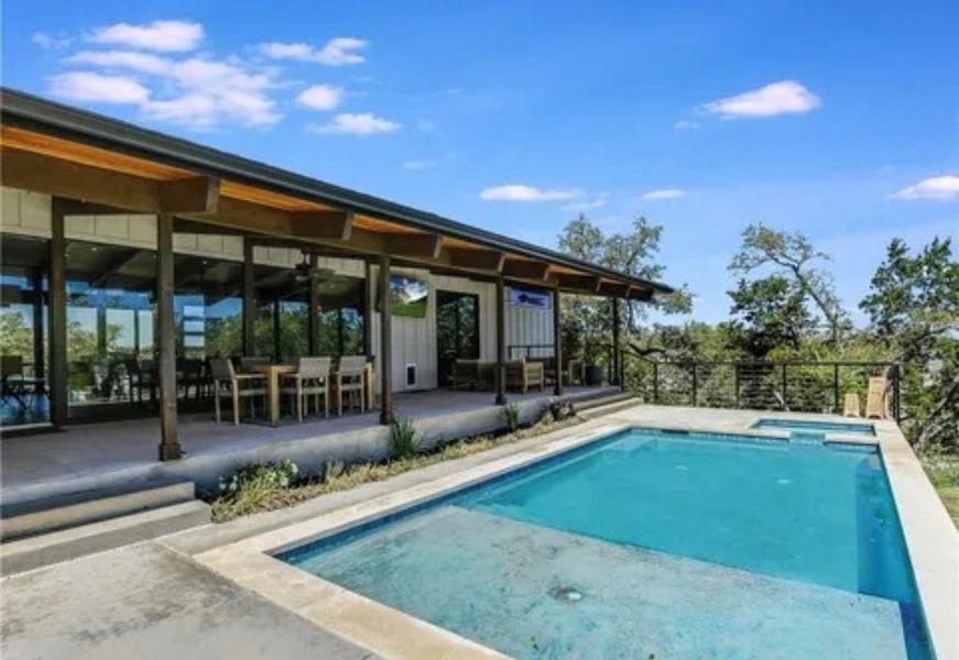 View of swimming pool featuring a patio area and a pool with connected hot tub View of swimming pool featuring a patio area and a pool with connected hot tub