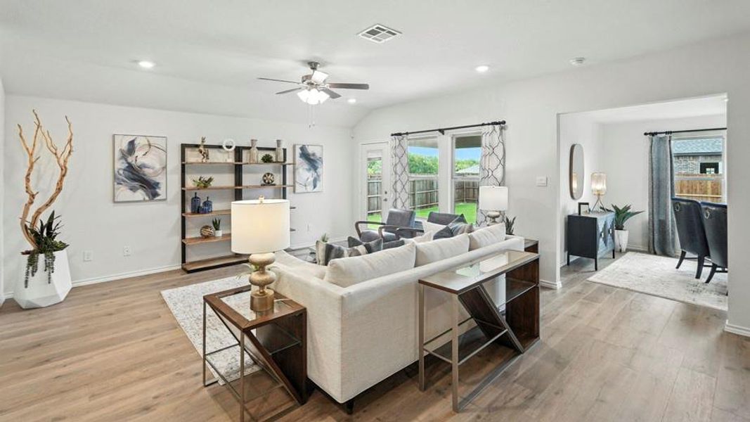 Living room featuring light wood-type flooring, vaulted ceiling, a ceiling fan, and recessed lighting Living room featuring light wood-type flooring, vaulted ceiling, a ceiling fan, and recessed lighting