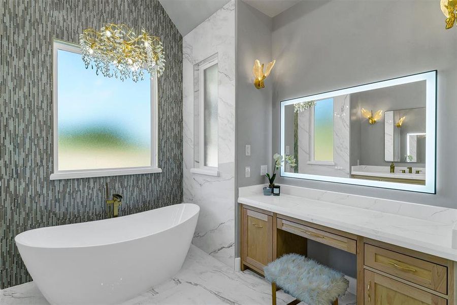 Bathroom with a tub to relax in, vaulted ceiling, and vanity