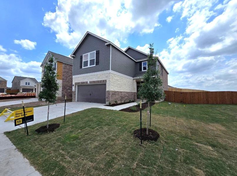 Front exterior of a new home in Salerno - Heritage Collection, Round Rock, TX, highlighting curb appeal (Image 18). Front exterior of a new home in Salerno - Heritage Collection, Round Rock, TX, highlighting curb appeal (Image 18).