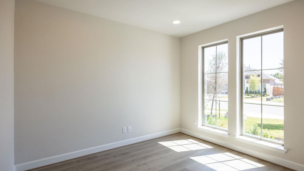 Spare room with wood finished floors and recessed lighting
