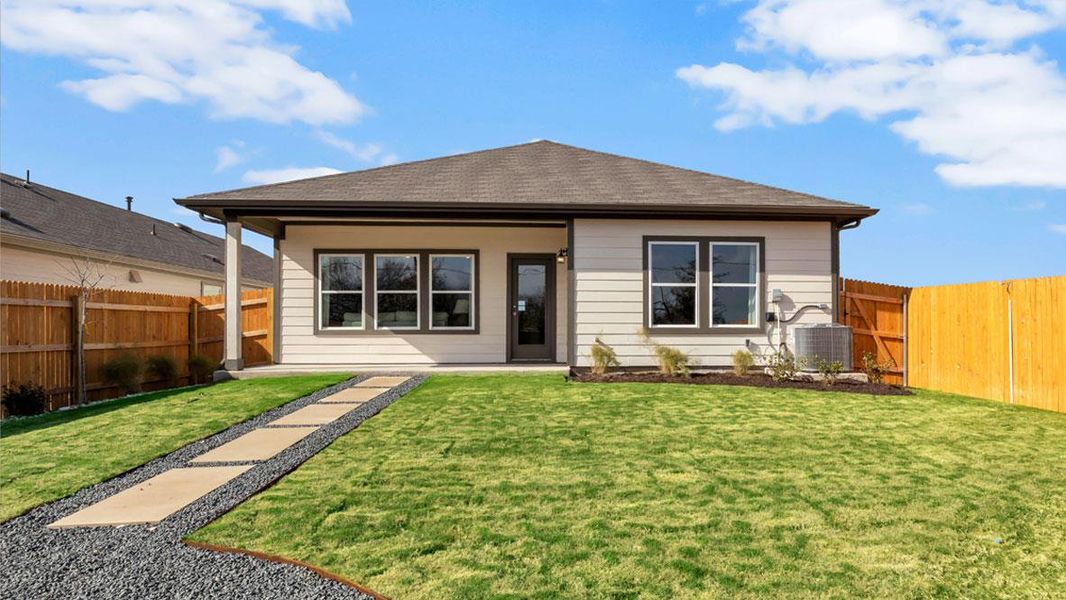 Front exterior of a new home in Carillon, Manor, TX, highlighting curb appeal (Image 1).