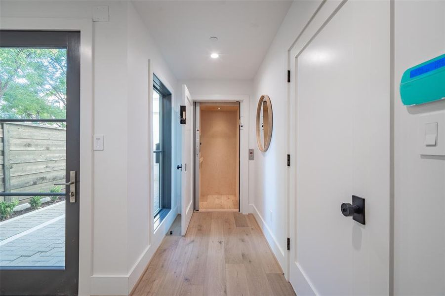 Hall with light hardwood / wood-style floors