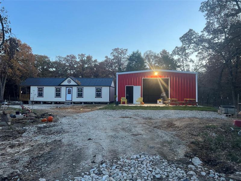 View of House and Metal Buildig