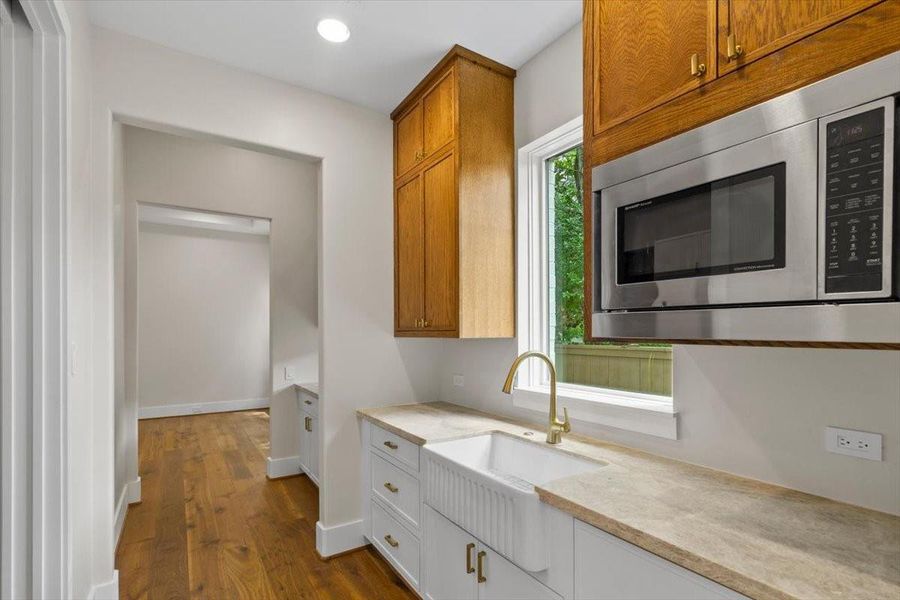 True scullery kitchen has a full size sink, microwave and a paneled dishwasher drawer...flows directly into dining room from kitchen